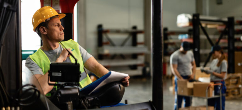a worker sitting on forklift